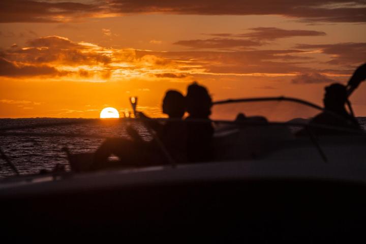 A couple drinking champagne onboard during a private boat tour in Bora Bora