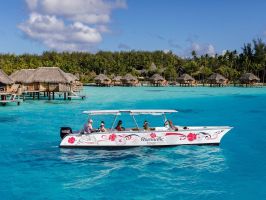 An outrigger canoe sailing in Bora Bora