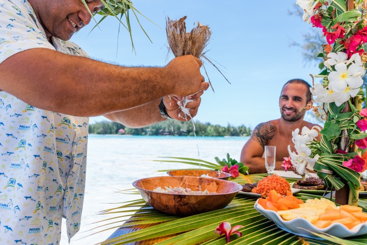 A man pouring coconut milk on 