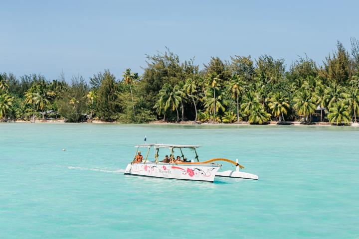 An outrigger canoe sailing in Bora Bora