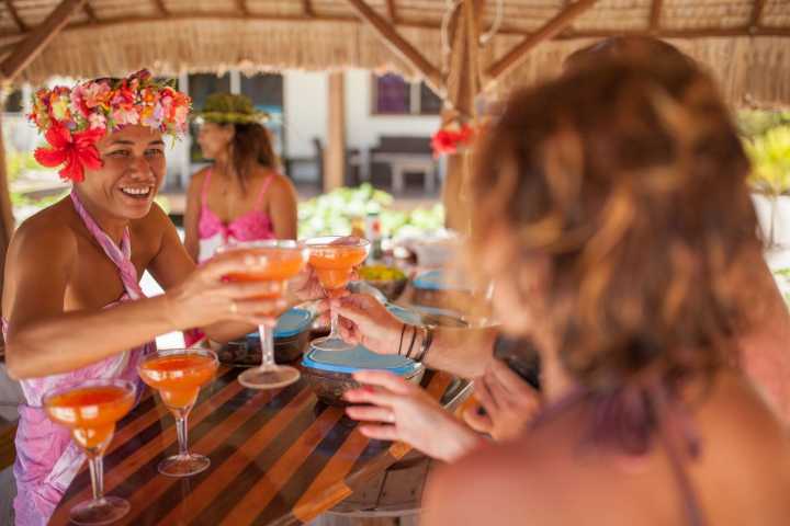 A woman serving cocktails to her guest in Bora Bora private island