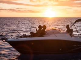 A couple drinking champagne onboard during a private boat tour in Bora Bora